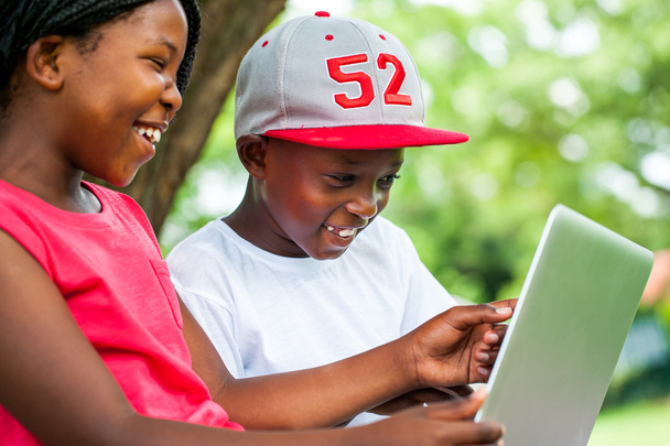 Αφρικανική τους νέους που απολαμβάνετε το χρόνο με laptop. - Φωτογραφία, εικόνα