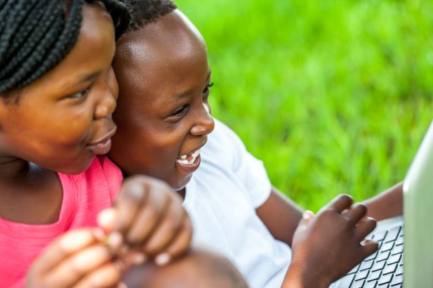 African kids having fun on laptop outdoors. - Valokuva, kuva