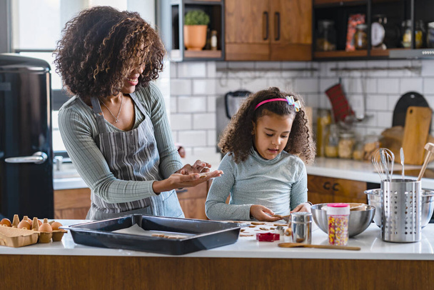 african american mother and daughter cooking cookies together  - Photo, Image