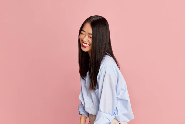 Positivity. Portrait of young beautiful happy girl in casual clothes posing, smiling against pink studio background. Concept of emotions, facial expression, fashion, youth, lifestyle. Ad - 写真・画像