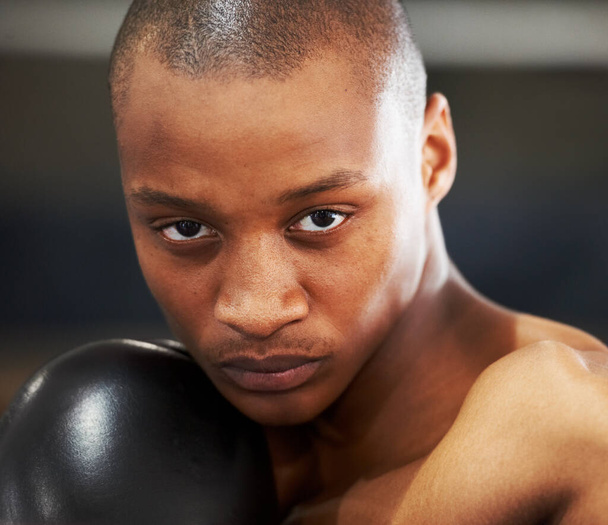 Resolved to succeed. A young boxer with determination and focus in his eyes - 写真・画像
