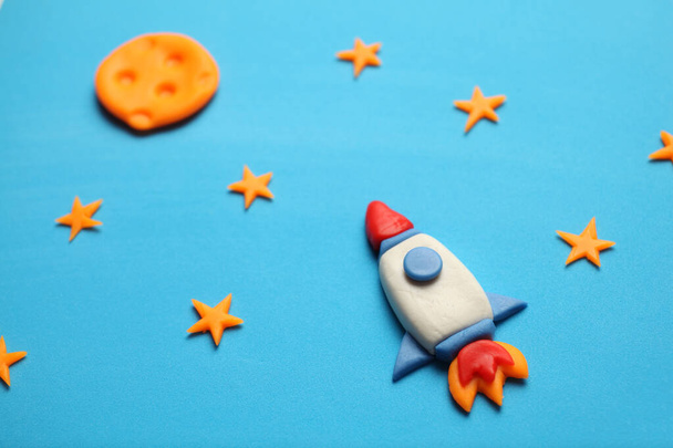 Rocket in space, star, and moon. Plasticine art, cartoon. - Фото, изображение