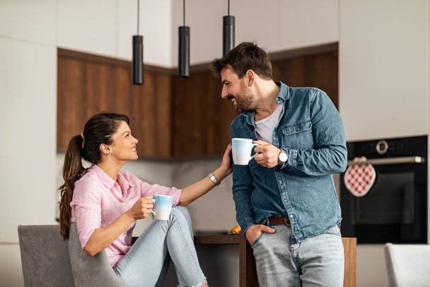 Couple drink coffee in the kitchen. Love,people and lifestyle concept.Coffee time. - Foto, imagen