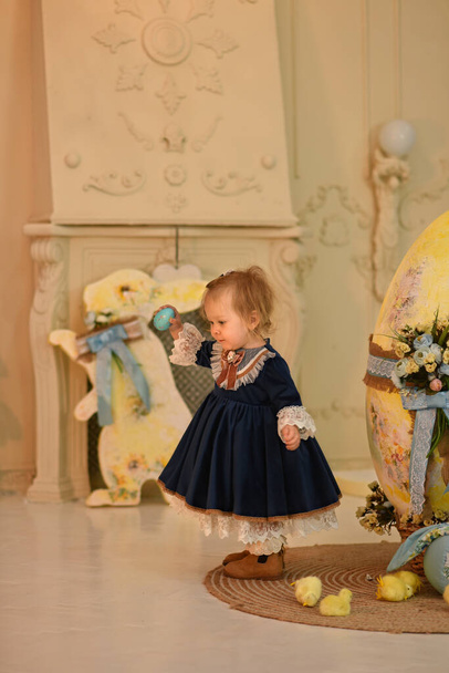 Little beautiful girl and Easter decor. Easter eggs. - Valokuva, kuva