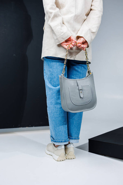 Women's leather stylish handbag. A blue everyday bag in a woman's hands. - Fotoğraf, Görsel