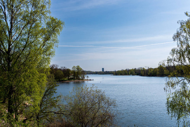 Landscape. Lake in spring, green trees, blue water and blue sky. - Foto, imagen