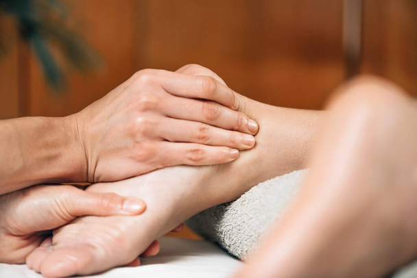 Ayurvedic foot massage. Ayurveda practitioner pressing meridian points on female foot - Foto, immagini