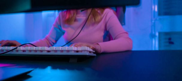 A Professional female pro gamer play online video games cyber sport and esport winner emotion. Young woman in tournament match worldwide in room colorful neon lights. - 写真・画像