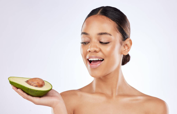Nourish your skin from within. a beautiful young woman posing with an avocado against a studio background - Photo, image