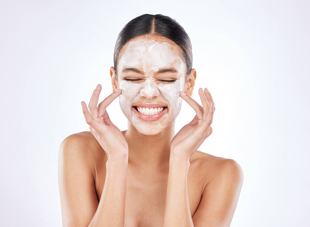 Heres to good skin health. a young woman posing against a studio background while wearing a face mask - Foto, Imagem
