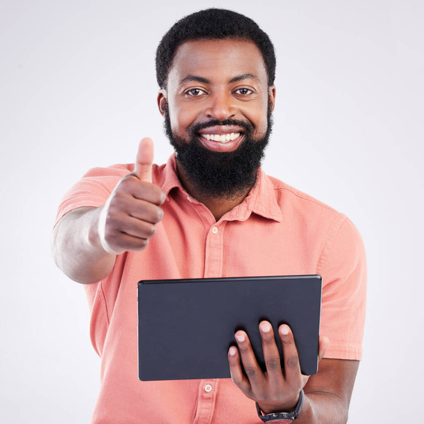 Thumbs up portrait, tablet or happy black man with emoji gesture for congratulations, job well done or winner. Agreement, finance results or studio person with yes sign for success on grey background. - Foto, Imagem
