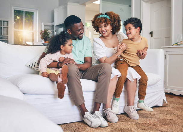 Black family, lounge and living room sofa of a mother, father and children with happiness. Happy, smile and bonding of a mom, dad and young kids together having fun with parent love and support. - Fotoğraf, Görsel