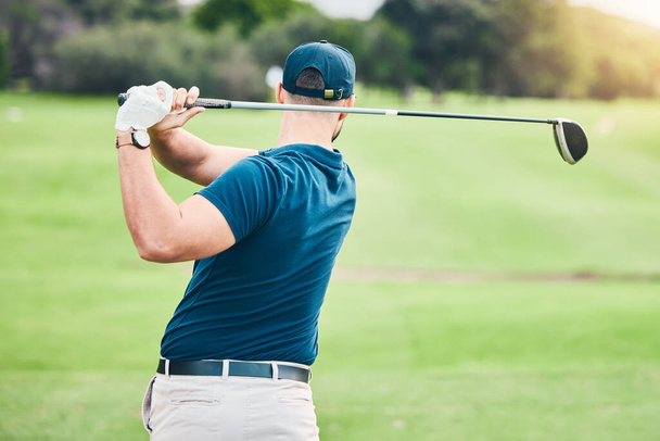 Golf stroke, sport swing and golfer outdoor for game, fitness and exercise on grass. Athlete back, training and man at a sports club for cardio and workout on a green course with focus and action. - Foto, Imagen