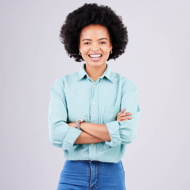 Smile, arms crossed and portrait of black woman in studio for confidence, positive and empowerment. Happiness, funny and elegant with female isolated on white background for young, excited and pride. - Fotó, kép