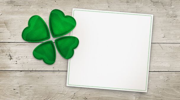 Four leaf clover and greeting card on wood background - Φωτογραφία, εικόνα