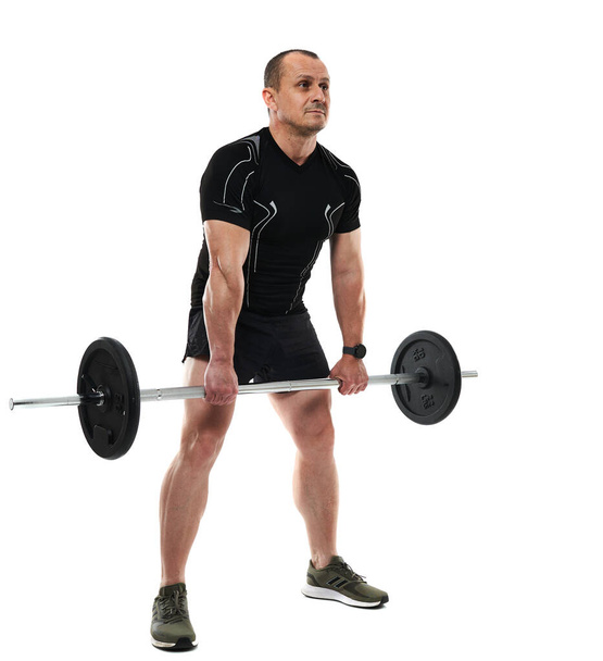 Athletic middle age man doing deadlift fitness workout with barbell, isolated on white background - Φωτογραφία, εικόνα