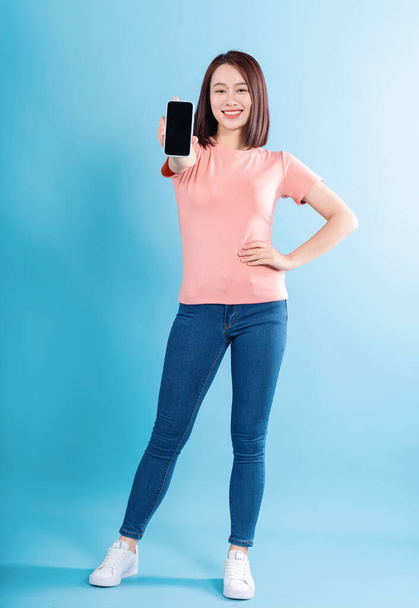 Asian woman on blue background - Фото, зображення