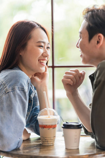 Young Asian couple dating at coffee shop - Photo, Image