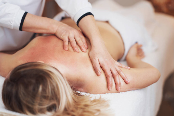 Woman having back body massage in studio. High quality photo - Zdjęcie, obraz