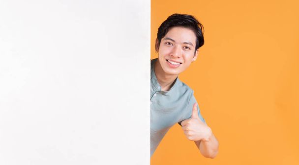 Portrait of young Asian man on background - Photo, Image