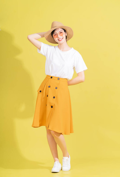 Full length photo of young Asian girl on yellow background - Fotoğraf, Görsel