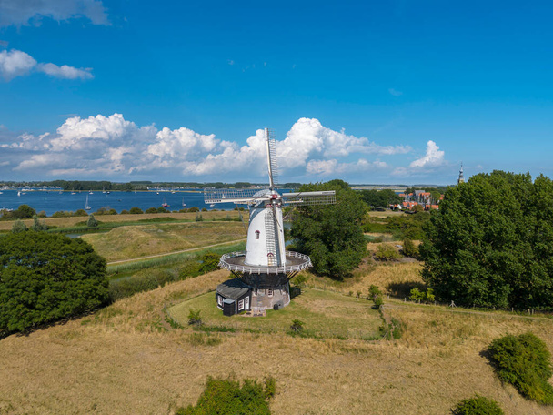 Aerial view with the windmill De Koe in Veere. In the background the inland water Veerse Meer. Veere is a city in the province of Zeeland in the Netherlands - Photo, Image