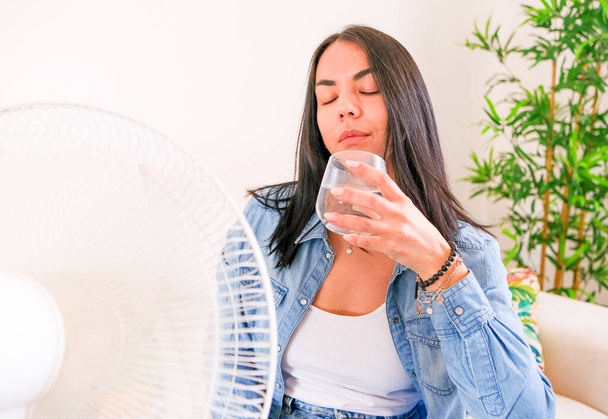 Woman suffering summer heat trying to stay cool and comfortable during heat wave - Photo, Image