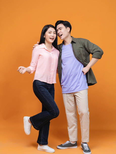 Young Asian couple standing on background - Photo, Image