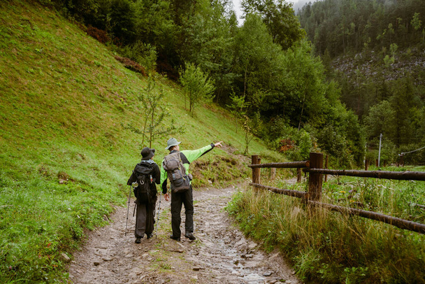 Young white people wearing trekking equipment hiking in mountain forest - Zdjęcie, obraz