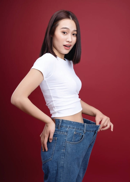 Young Asian woman weight loss background - Foto, imagen