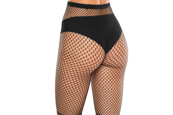 young female bottom in black fishnet stockings on white studio background - Foto, afbeelding