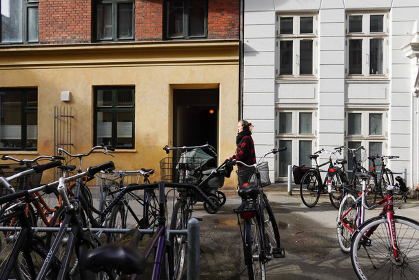 Copenhagen, Denmark A young woman with a baby pram walking in the Norrebro district. - 写真・画像