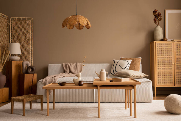 Creative composition of living room interior with modular sofa, wooden coffee table, rattan sideboard, beige rug, pillows and personal accessories. Home decor. Template.  - Φωτογραφία, εικόνα