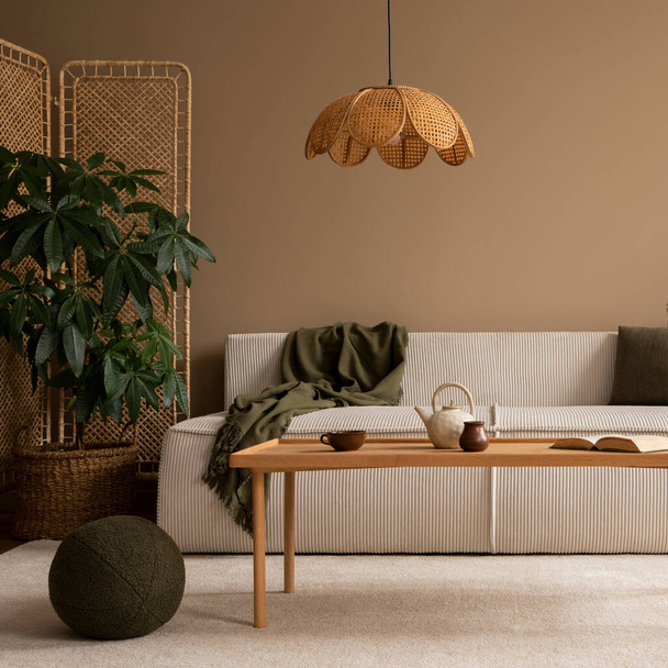 Warm and cozy composition of living room interior with modular sofa, wooden coffee table, rattan sideboard, lamp, round green pillows  and personal accessories. Home decor. Template.  - Zdjęcie, obraz