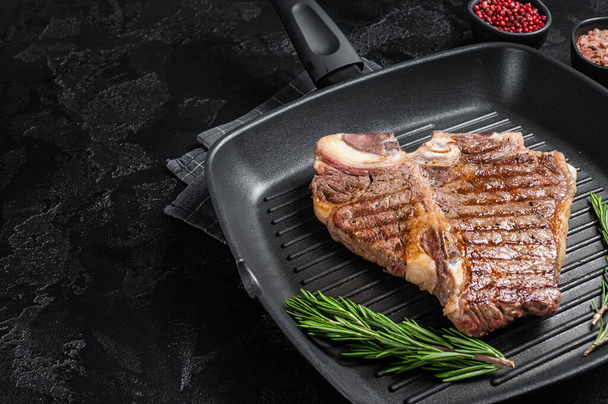 Fried on a grill skillet t bone porterhouse beef meat Steak. Black background. Top view. Copy space. - Valokuva, kuva