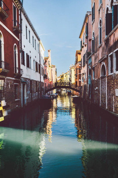 Canal in sunshine with bridge in Venice, Italy. Historic Italian city on water - Photo, Image