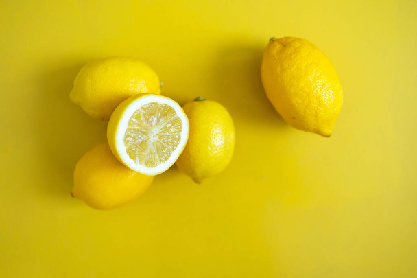 Fresh lemon on a yellow background. - Фото, изображение
