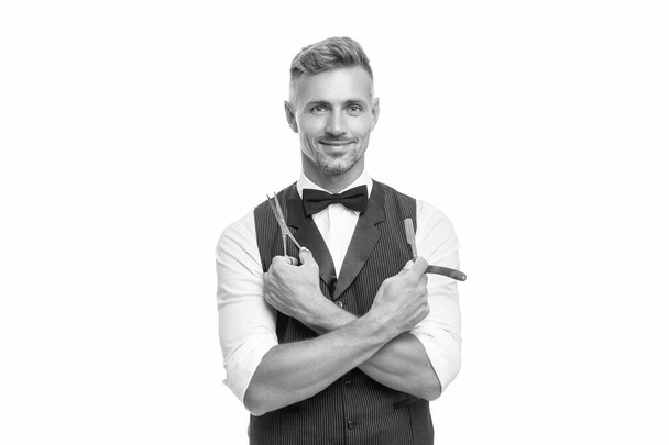 cheerful man barber with razor blade and scissors in bow tie isolated on white background. - Foto, imagen