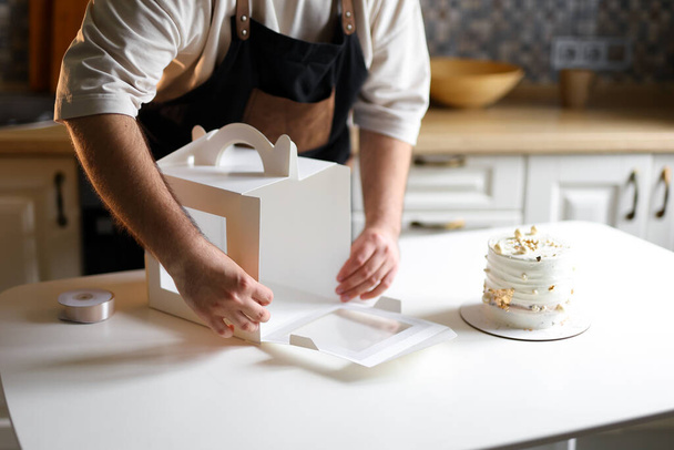 confectioner prepares a cake, bento cake, decorates a cake, step by step cake making process, cake packaging. High quality photo - Zdjęcie, obraz