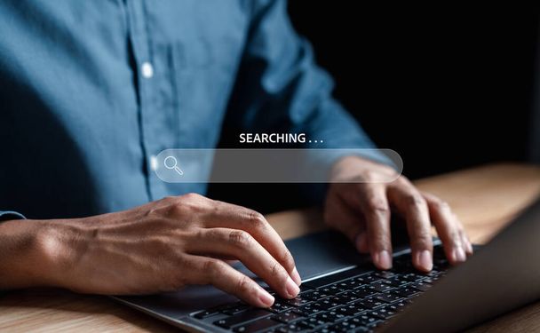 Businessman use magnifying glass Search On Virtual Screen Data Search Technology Search Engine Optimization. Man use computer to Searching for information. Using Search Console for data. - Foto, imagen