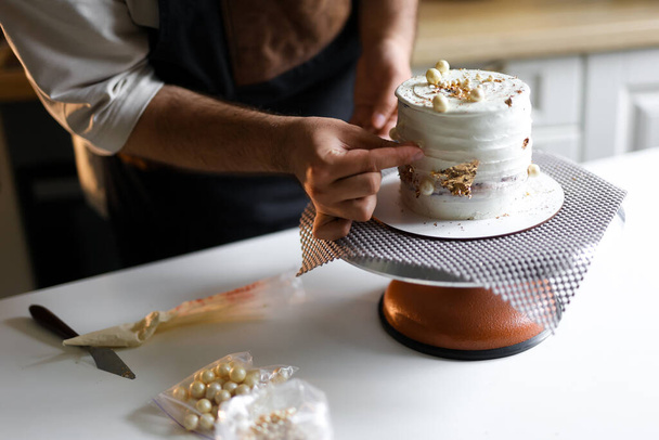 confectioner prepares a cake, bento cake, decorates a cake, the process of making a cake step by step. High quality photo - Zdjęcie, obraz
