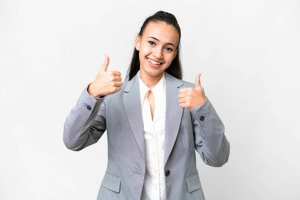 Young Arabian woman over isolated white background giving a thumbs up gesture - 写真・画像