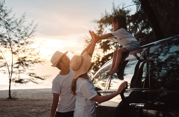 Family with Car travel driving road trip summer vacation in car in the sunset, Dad, mom and daughter happy traveling enjoy holidays and relaxation together get the atmosphere and go to destination  - Foto, Imagen