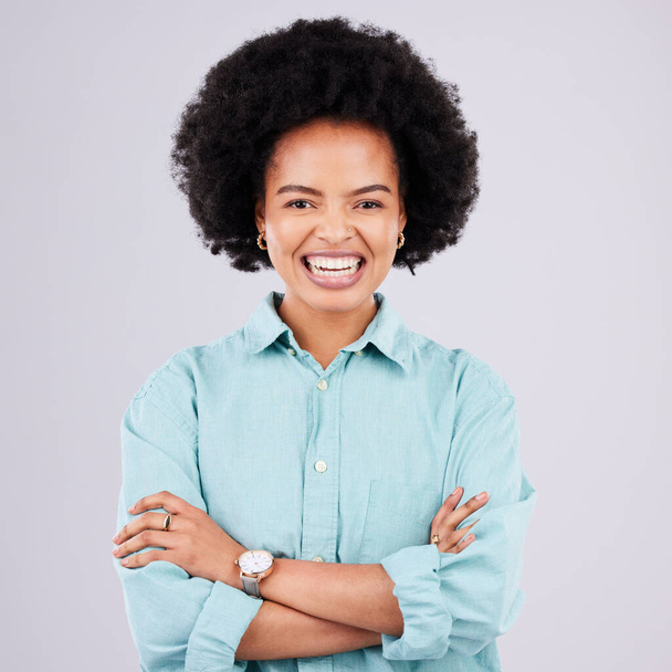 Happy, arms crossed and portrait of black woman in studio for confidence, positive and empowerment. Happiness, funny and elegant with female isolated on white background for young, excited and pride. - 写真・画像