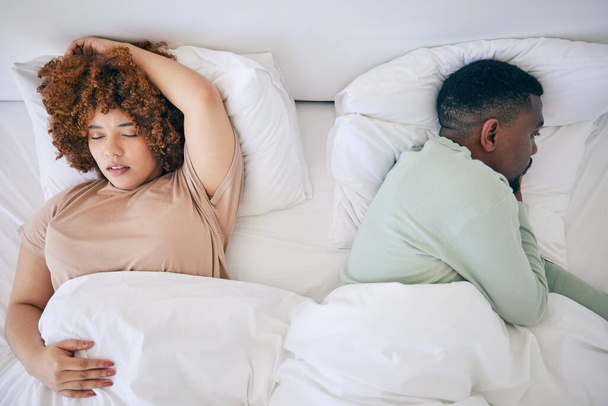 Top view, sleeping and black couple in bed in morning after fighting, argument and relationship problem. Depression, dating and male in bed with woman with sexual frustrated, infertility and stress. - 写真・画像