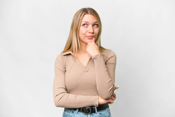 Junge hübsche blonde Frau über isolierten weißen Hintergrund mit Zweifeln und Denken - Foto, Bild