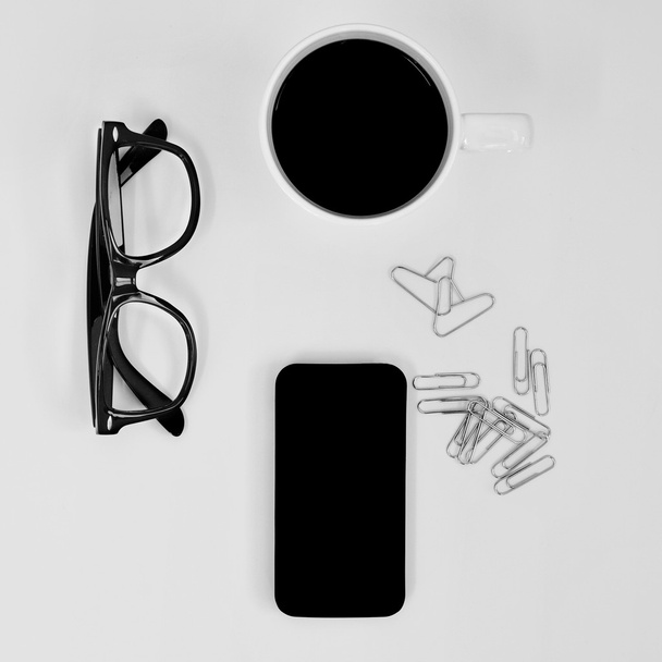 Szemüvegek, okostelefon, a kávé és a szív alakú gémkapcsot - Fotó, kép