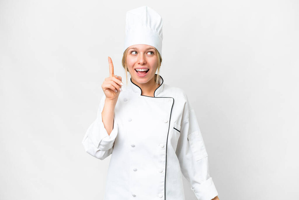 Young chef woman over isolated white background intending to realizes the solution while lifting a finger up - Фото, зображення