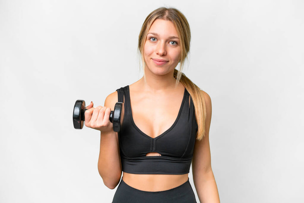 Blonde sport woman making weightlifting over isolated white background smiling a lot - Foto, Imagem