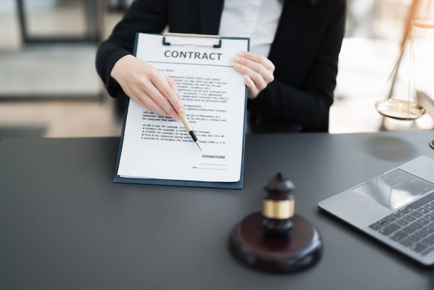 The lawyer with a client discussing contract paper, a Business lawyer working about legal legislation in the courtroom to help their customer, contract and agreement concept - Photo, image